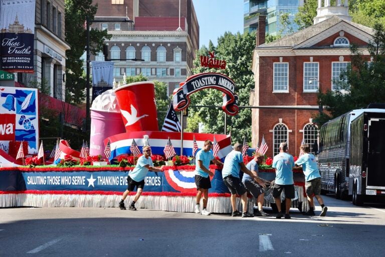 Workers turn a float around on Fifth Street after Philadelphia’s Fourth of July parade was canceled due to dangerously high temperatures.
