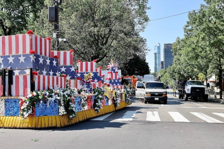 Workers take down temporary fencing on Fifth Street near Independence Mall in Philadelphia