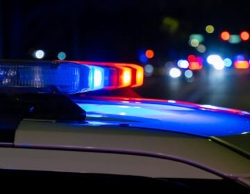 Close up of a siren on top of a police car at night.