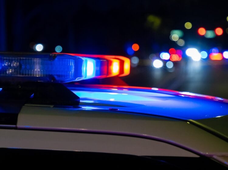 Close up of a siren on top of a police car at night.