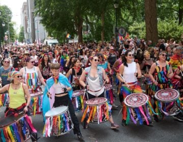 Drummers lead a Pride parade
