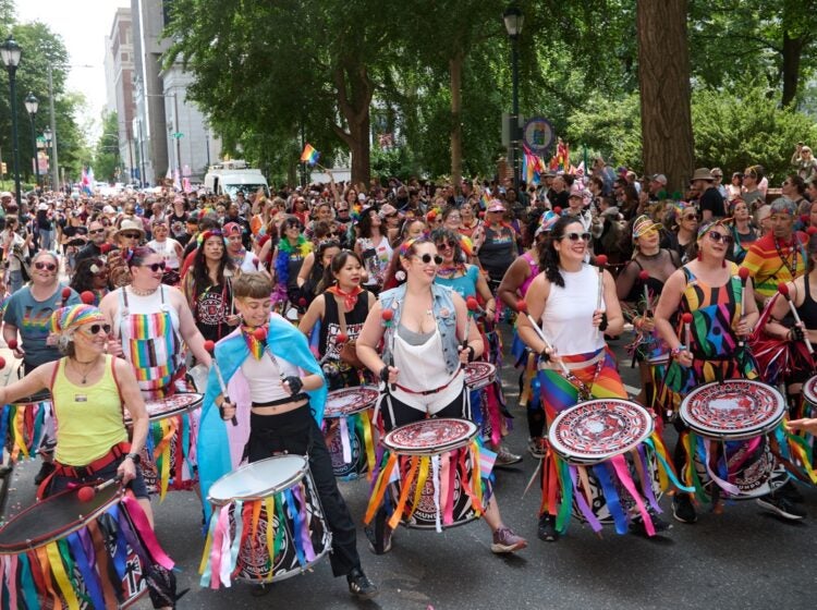 Drummers lead a Pride parade
