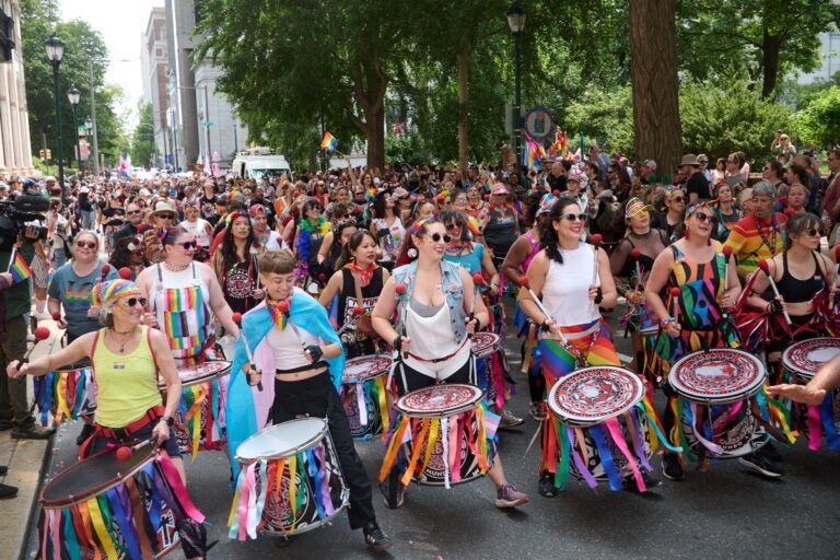 Drummers lead a Pride parade