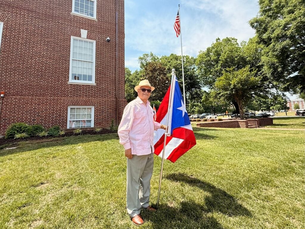 A Puerto Rican attendee proudly holds the Puerto Rican flag