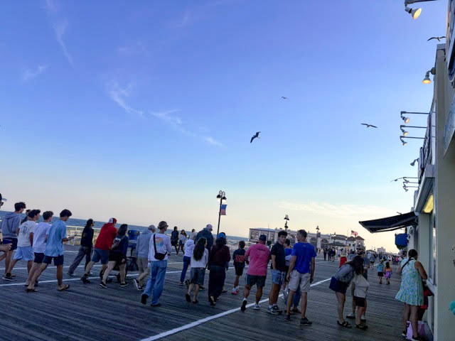 People walking on the Ocean City boardwalk.