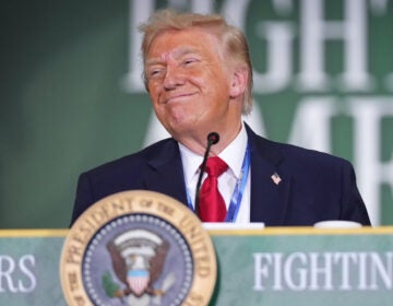 Trump President Donald Trump stands behind a podium