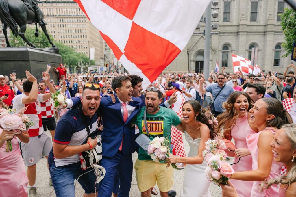 Croatian fans crashing a wedding party photo shoot outside of City Hall.