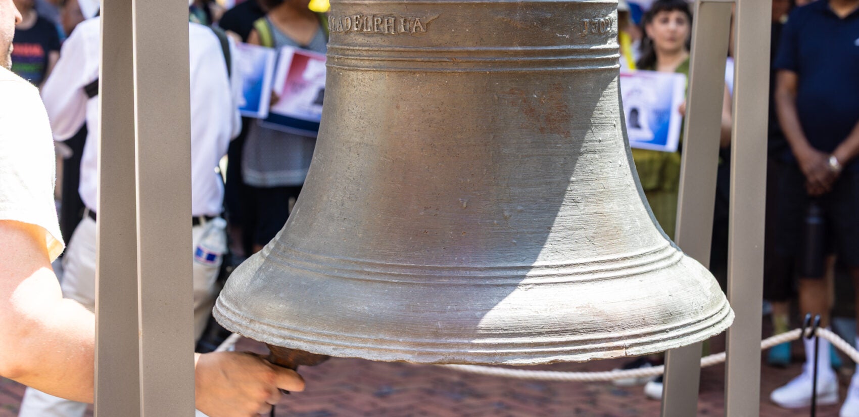 A replica liberty bell being rung at the vigil.