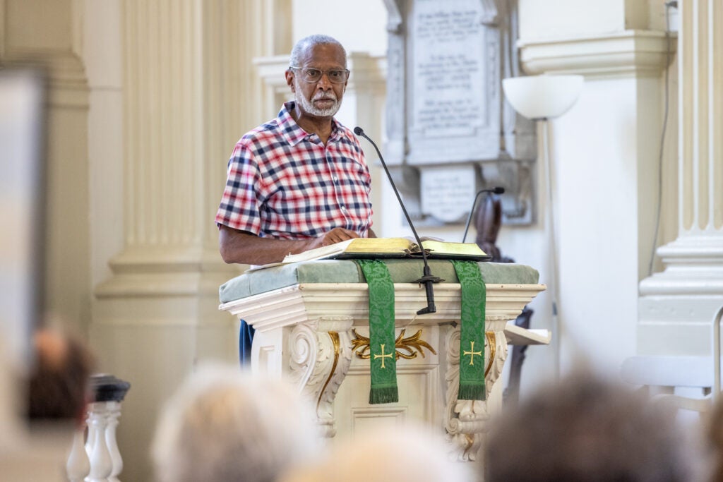 State Senator Art Heywood speaking at a podium in the church.