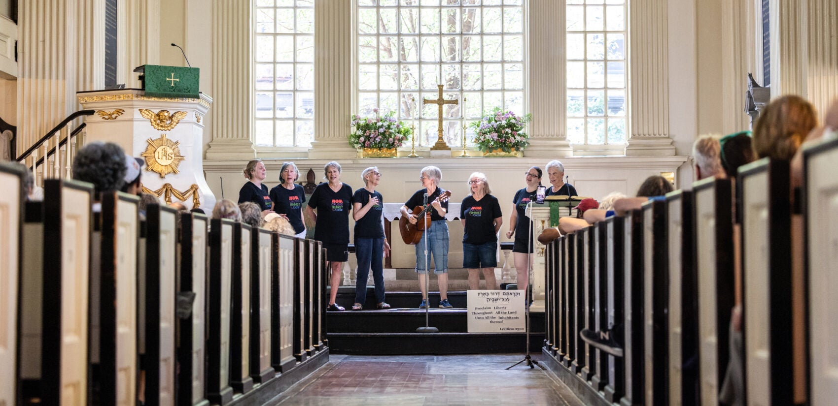 A choir singing on stage at the church.