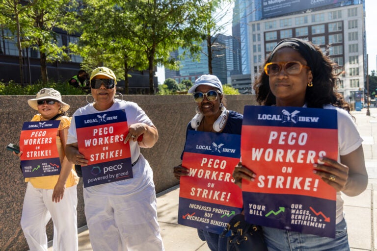 Striking PECO workers picket outside the company headquarters
