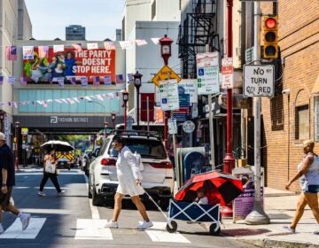 People walking across a busy intersection