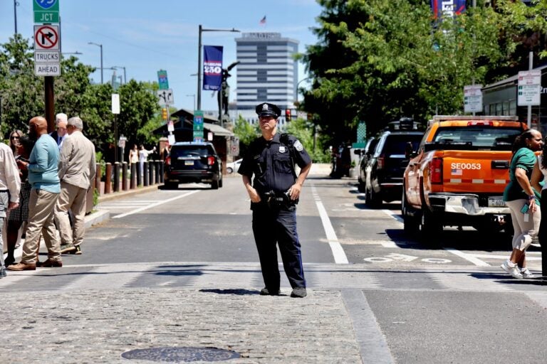 A Philadelphia police officer directs traffic at 2nd and Market streets.