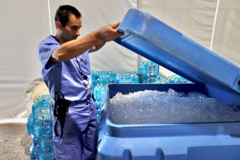Emergency physician Jonathan Bar lifts the lid on a large tub of ice in the medical services tent at the FIFA Fan Fest