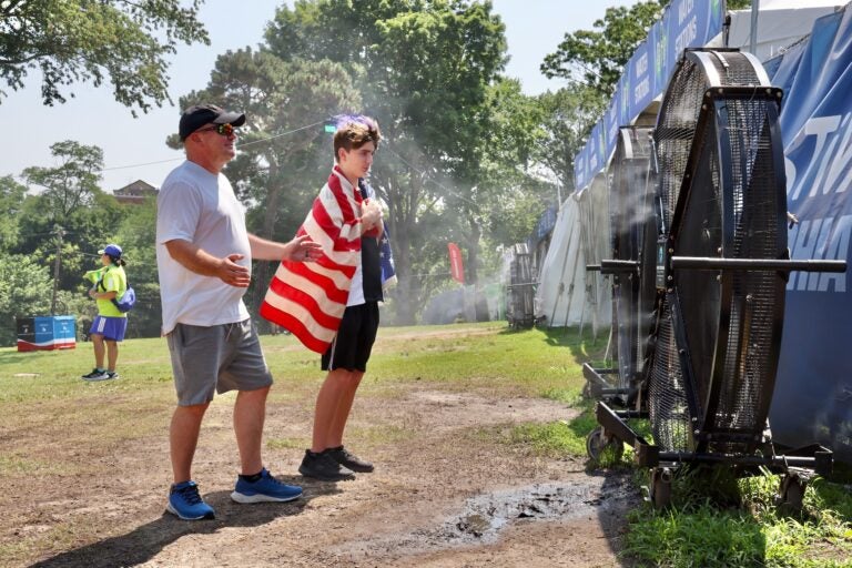 Patrick Ullman of Pottstown and his son, Tanner, 14, cool off