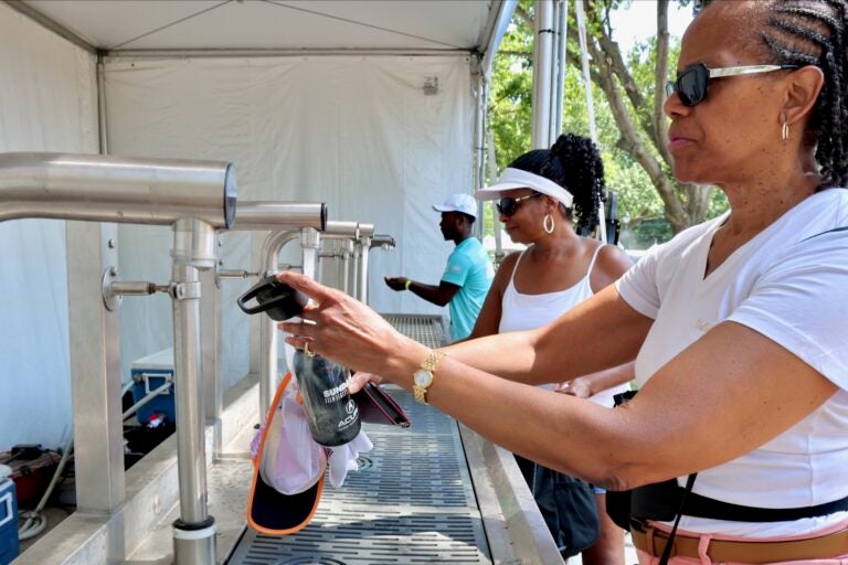 Visitors to FIFA Fan Fest at Lemon Hill fill their water bottles