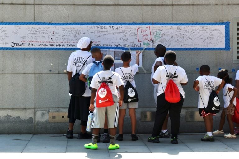 A summer camp group visits the President's House slavery exhibit at Sixth and Market streets in Independence National Historical Park.