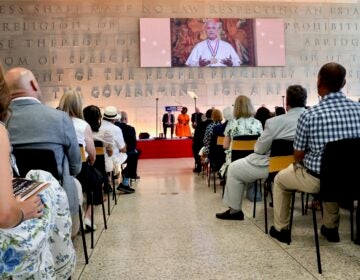 2026 07 03-e lee-pope leo xiv-philadelphia national constitution center-liberty medal ceremony remarks People in the audience at the National Constitution Center watch Pope Leo XIV's video remarks on a large screen.