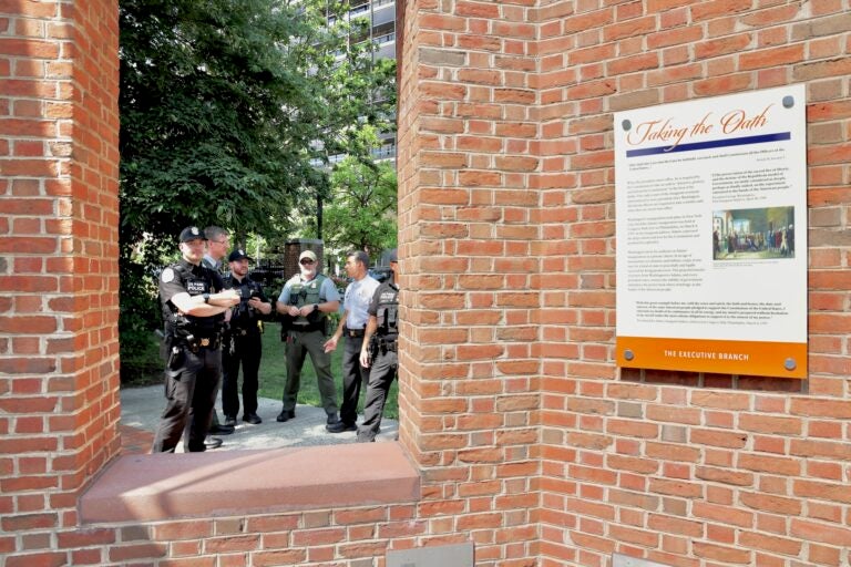 Officers grouped together, standing near the slavery exhibit.
