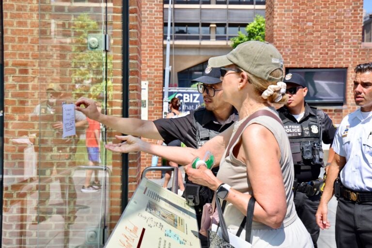 An officer removing the sign from the panel.