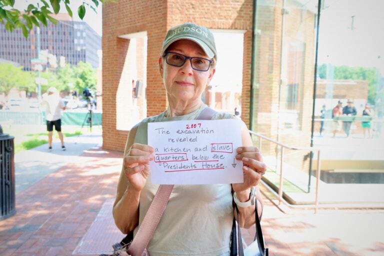Sandra Shachar-Krasnoff holds up a protest sign.