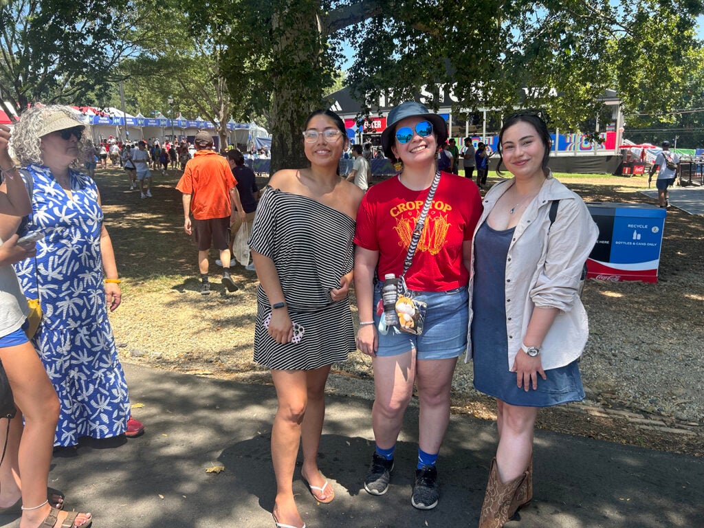 Three women stand outside at the Philadelphia FIFA Fan Fest