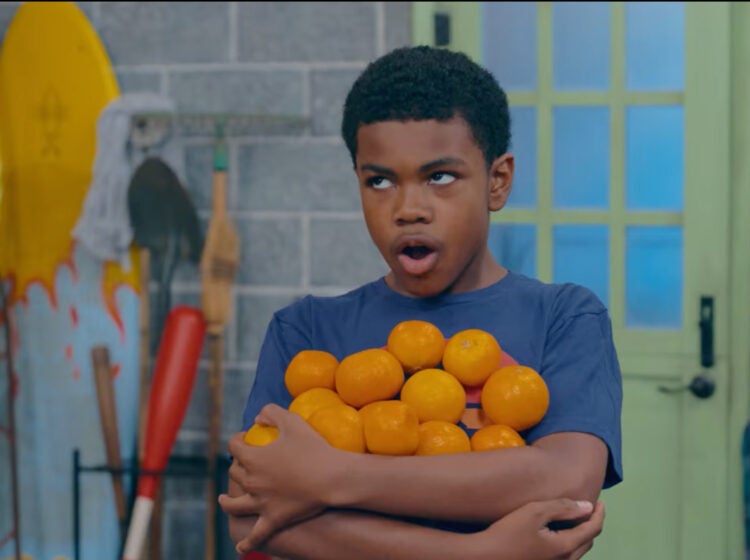 Good Neighbor Club cast member holding oranges