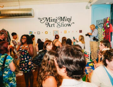 Attendees packed into At My House vintage shop for the Mini Mini Art Show's Friday night opening.