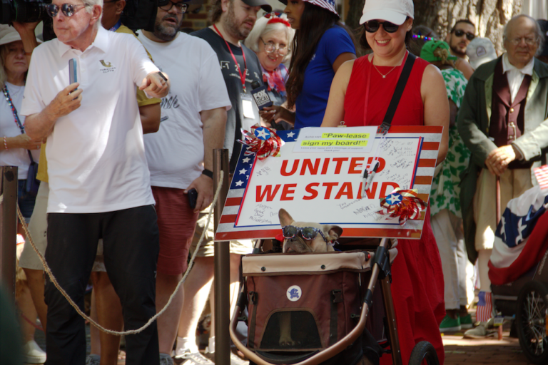 Archie with patriotic sign at dog show competition
