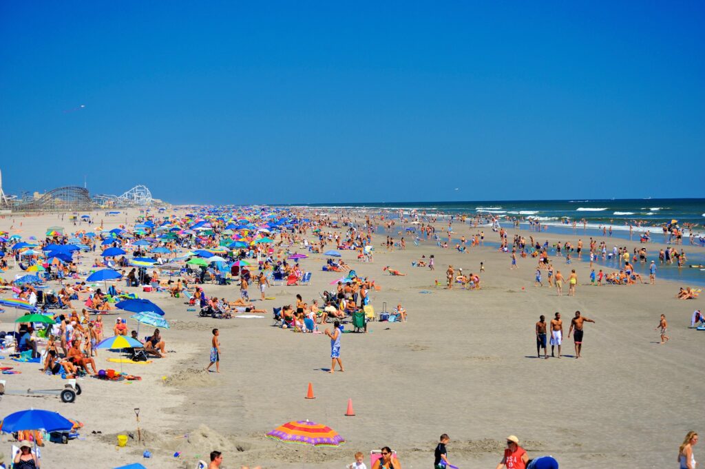 Many people on the beach on a sunny day.