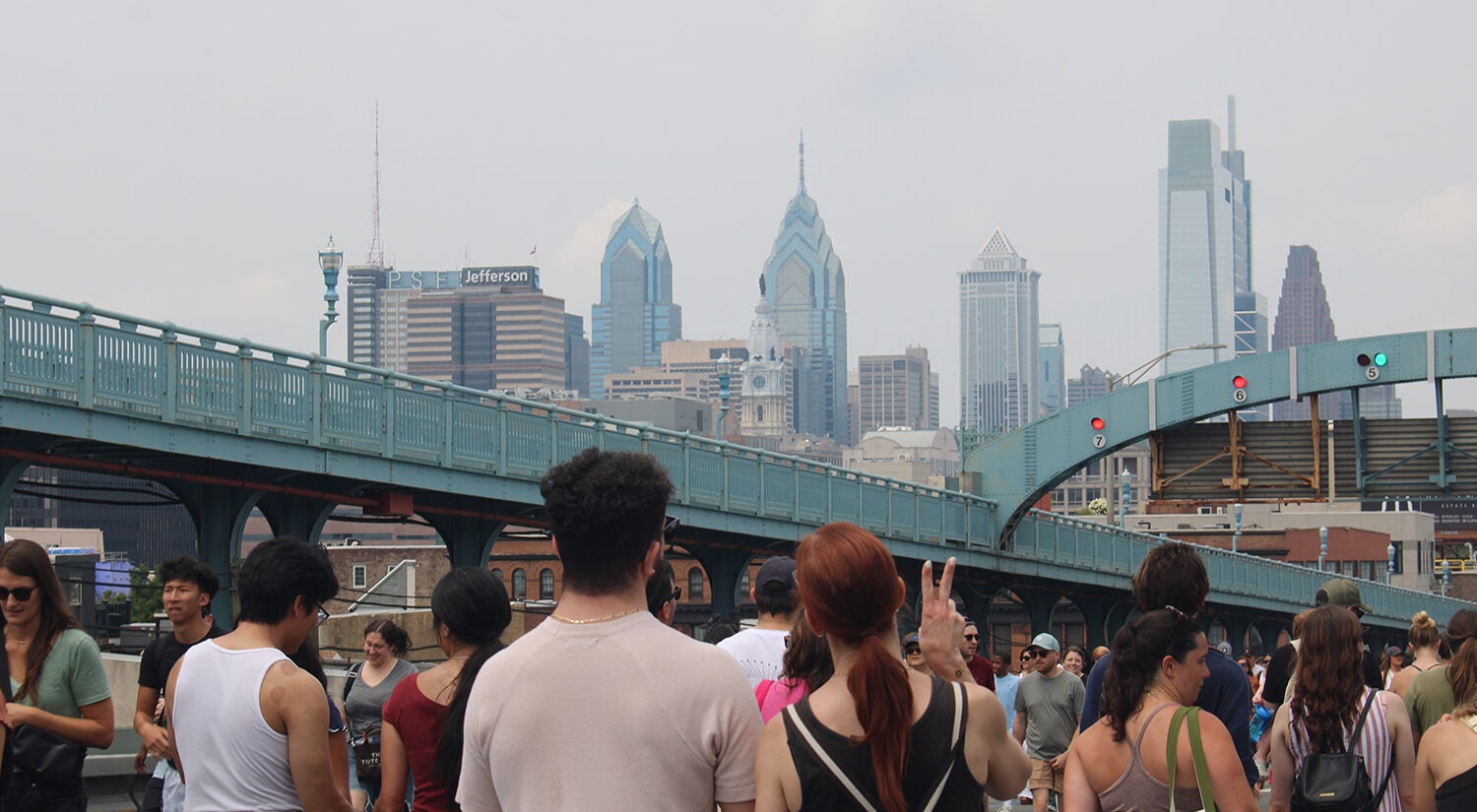People look toward the Philadelphia skyline on the Ben Franklin Bridge