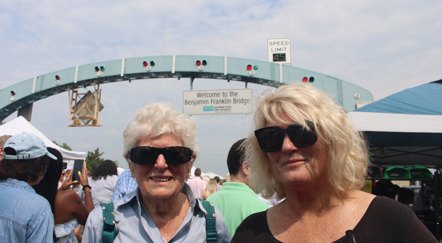 Two women pose for a photo on the Ben Franklin Bridge