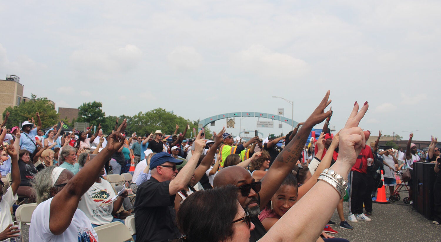 People put their hands in the air in response to Philadelphia Mayor Cherelle Parker's speech at the celebration of the Benjamin Franklin Bridge's 100th birthday on Saturday, July 11, 2026. (Emily Neil/WHYY)