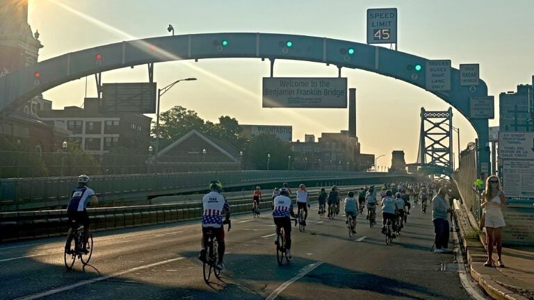 bikers bicycling on Ben Franklin Bridge