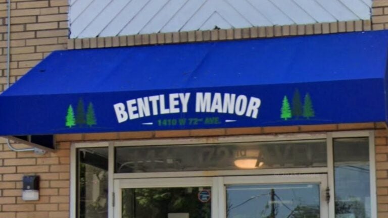 a sign at the Bentley Manor apartment complex
