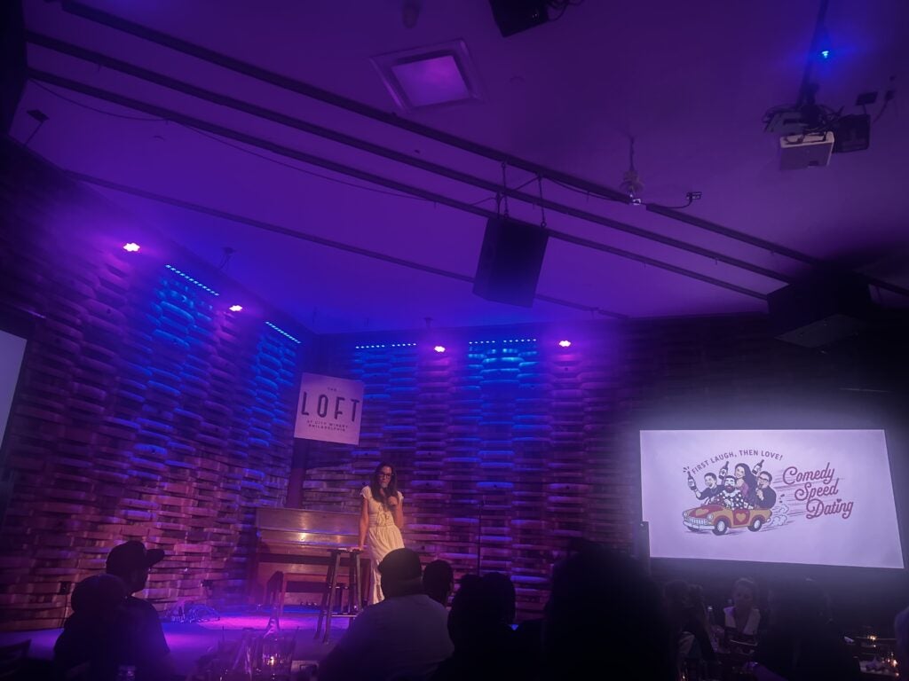 Kerryn Feehan performing at a speed-dating comedy event
