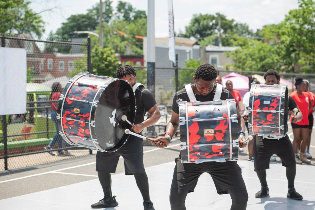 Drummers performing in the street as a drumline.
