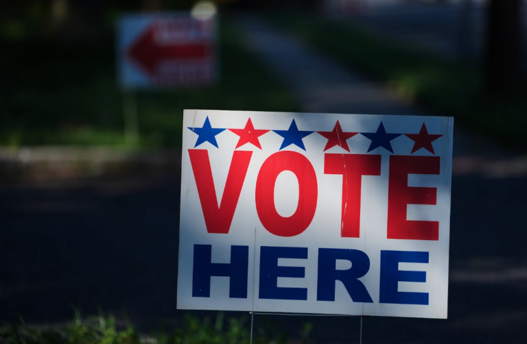 A ''Vote Here'' sign on a lawn directs voters to a polling place for an election on June 2, 2026.