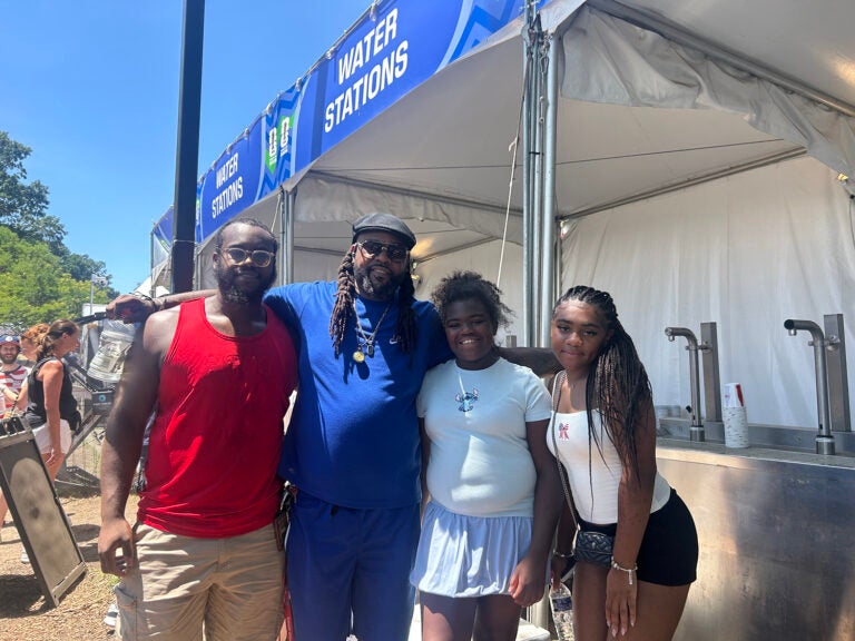 A family poses for a picture in from of a water station at the FIFA Fan Fest in Philadelphia