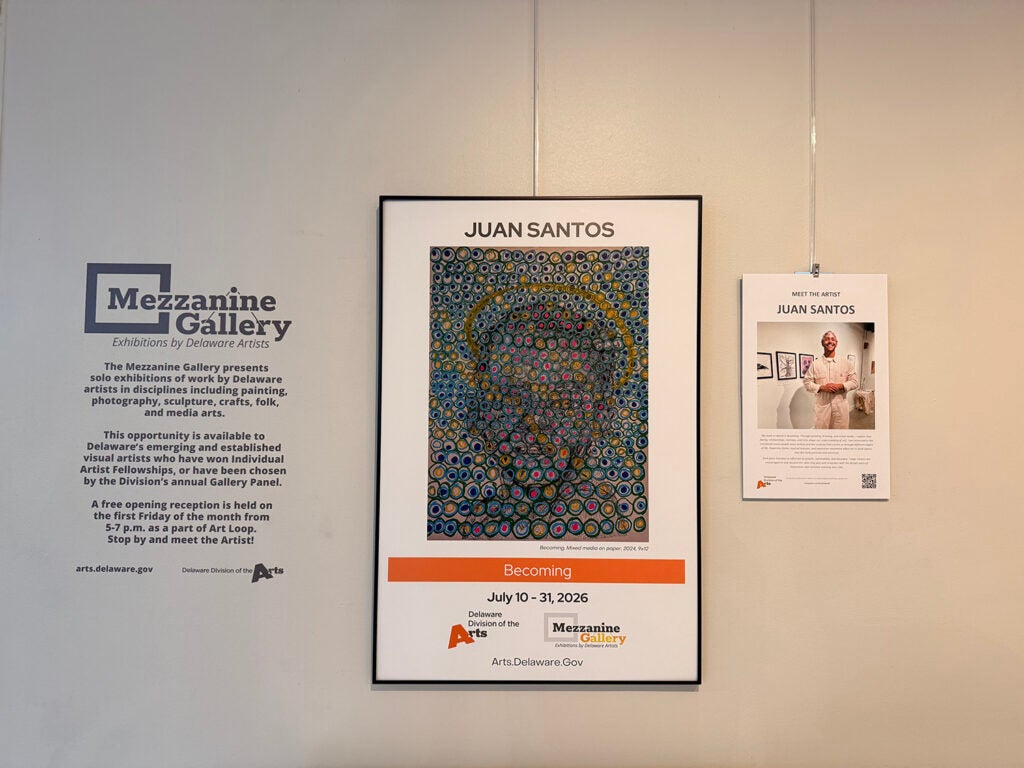 Paintings hang in an exhibit in Delaware