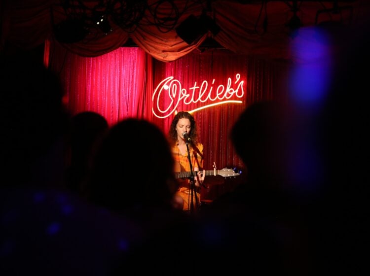 Mallory Hawk singing and playing guitar onstage