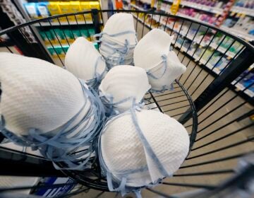 Virus Outbreak Masks Reaction FILE - A product stall filled with free N95 respirator masks, provided by the U.S. Department of Health and Human Services, sits outside the pharmacy at this Jackson, Miss., Kroger grocery store, Wednesday, Feb. 2, 2022. (AP Photo/Rogelio V. Solis)