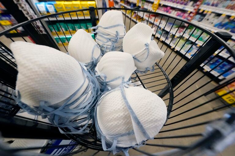 FILE - A product stall filled with free N95 respirator masks, provided by the U.S. Department of Health and Human Services, sits outside the pharmacy at this Jackson, Miss., Kroger grocery store, Wednesday, Feb. 2, 2022. (AP Photo/Rogelio V. Solis)