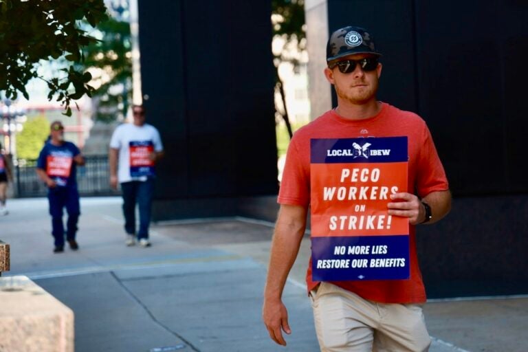 Striking PECO workers picket outside the company headquarters