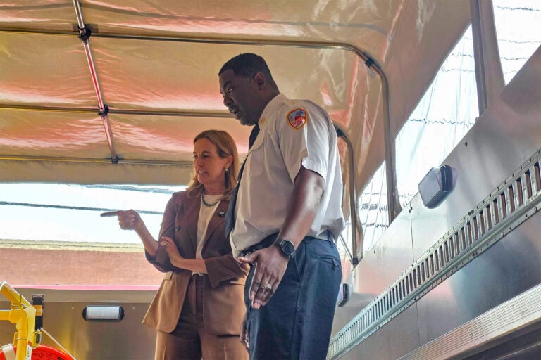 Mikie Sherrill and Jesse Flax discussing rescue equipment after the bad flooding.
