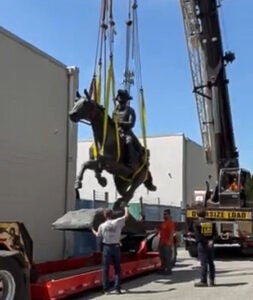 Statue being lifted by a crane