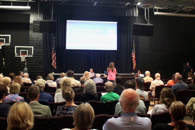 Residents are in the audience for the town hall meeting.