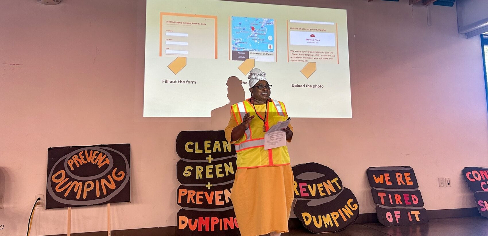 Teea Tynes speaking to the group and giving a powerpoint presentation.