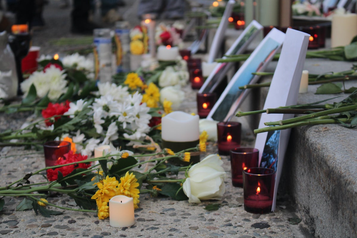 An altar with photos, flowers and incense to honor those killed by immigration officers.