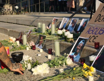 vigil-ice-3 An altar with photos, flowers and incense to honor those killed by immigration officers.